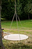 DESIGNER: CLARE MATTHEWS - SWINGING COCOON PROJECT: ROPE AND PLYWOOD COCOON FRAME HANGING FROM TREE