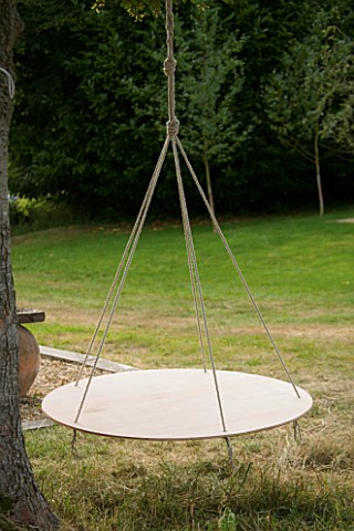 DESIGNER_CLARE_MATTHEWS__SWINGING_COCOON_PROJECT_ROPE_AND_PLYWOOD_COCOON_FRAME_HANGING_FROM_TREE