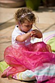DESIGNER CLARE MATTHEWS: CHILDRENS PARTY - GIRL EATING PICNIC AT PARTY