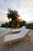 SUNBEDS BESIDE POOL AT DAWN IN GINA PRICES CORFU GARDEN.