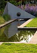 RICHARD JACKSONS GARDEN. DESIGNED BY CLARE MATTHEWS - WATER FEATURE - RECTANGULAR POOL/ POND WITH METAL SAIL AND FOUNTAIN