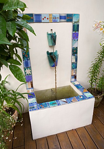 MEDITERRANEAN_DECKED_COURTYARD_WITH_TILED_WATER_FEATURE_POOL_POND_KATHY_TAYLORS_GARDEN__LONDON