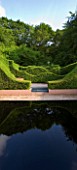 VEDDW HOUSE GARDEN  GWENT  WALES: DESIGNERS ANNE WAREHAM AND CHARLES HAWES - THE REFLECTING POOL WITH GRAVEL AND WAVE HEDGING