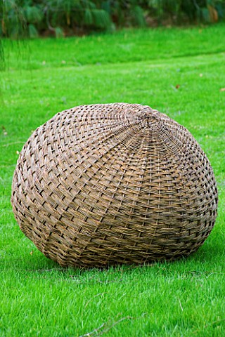 WOODPECKERS__WARWICKSHIRE__WINTER_LAWN_WITH_WOVEN_WILLOW_SCULPTURE