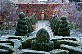 WOODPECKERS  WARWICKSHIRE  WINTER: THE FORMAL TOPIARY GARDEN IN FROST WITH KNOT GARDEN AND BOX TOPIARY TWIRLS  STATUE AND BEECH HEDGE