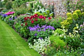 BIRTSMORTON HALL  WORCESTERSHIRE: HERBACEOUS BORDER IN THE WALLED GARDEN WITH EUPHORBIA  STACHYS  CARDOON  GERANIUM JOHNSONS BLUE PEONY BETHCAR AND PEONY STREPHON