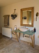 BOONSHILL FARM  EAST SUSSEX. INTERIOR OF BATHROOM WITH STONE FLOOR AND SINK/BASIN DESIGNED BY LISETTE PLEASANCE