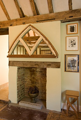 BOONSHILL_FARM__EAST_SUSSEX_INTERIOR_OF_BEDROOM_WITH_FIREPLACE_AND_MIRROR_MADE_FROM_OLD_WINDOW_FRAME