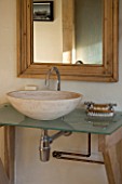 BOONSHILL FARM  EAST SUSSEX. INTERIOR OF BATHROOM WITH STONE SINK/BASIN ON GLASS TOP. DESIGNER: LISETTE PLEASANCE