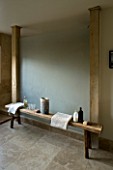 BOONSHILL FARM  EAST SUSSEX. INTERIOR OF BATHROOM WITH WOODEN BENCH WITH MOTHER OF PEARL INLAY FROM INDIA. DESIGNER: LISETTE PLEASANCE