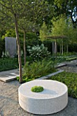 CHELSEA FLOWER SHOW 2007: CONTEMPORARY GARDEN DESIGNED BY ULF NORDFJELL. LINNAEUS GARDEN. GRANITE CIRCLE SEAT WITH FOLIAGE PLANTING OF BETULA AND PINUS SYLVESTRIS IN FORMAL GRID