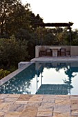 CORFU  GREECE: VILLA ZOGRAFIA  NORTH EAST CORFU. DESIGN BY ALITHEA JOHNS OF SKOPOS DESIGN AND RAHDY ELWAN. SWIMMING POOL WITH COVERED DINING AREA IN EARLY MORNING
