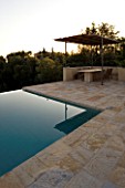 CORFU  GREECE: VILLA ZOGRAFIA  NORTH EAST CORFU. DESIGN BY ALITHEA JOHNS OF SKOPOS DESIGN AND RAHDY ELWAN. SWIMMING POOL WITH COVERED DINING AREA IN EARLY MORNING