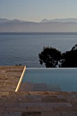 CORFU  GREECE: VILLA ZOGRAFIA  NORTH EAST CORFU. DESIGN BY ALITHEA JOHNS OF SKOPOS DESIGN AND RAHDY ELWAN. SWIMMING POOL WITH VIEWS OVER SOUKIA BAY. EARLY MORNING