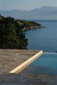 CORFU  GREECE: VILLA ZOGRAFIA  NORTH EAST CORFU. DESIGN BY ALITHEA JOHNS OF SKOPOS DESIGN AND RAHDY ELWAN. SWIMMING POOL WITH VIEWS OVER SOUKIA BAY. EARLY MORNING