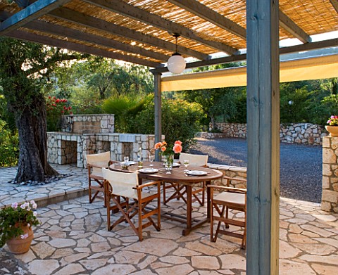 CORFU__GREECE_MALAMA_HOUSE_NEAR_BARBATI_PATIO_DINING_AREA_WITH_TABLE_AND_CHAIRS_AND_BARBEQUE_SET_FOR