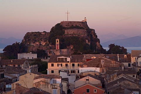 CORFU__GREECE_VIEW_OF_CORFU_TOWN_ROOFTOPS_AND_THE_OLD_FORTRESS_AT_SUNSET