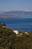 CORFU  GREECE: VIEW OF YIALISKARI HOUSE WITH ALBANIAN MOUNTAINS BEYOND