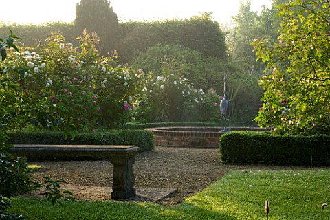 MARINERS_GARDEN__BERKSHIRE_DESIGNER_FENJA_ANDERSON__VIEW_INTO_THE_ROSE_GARDEN_AT_DAWN_TO_THE_WATER_L