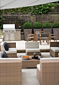 CONTEMPORARY TOWN/CITY/URBAN GARDEN DESIGNED BY CHARLOTTE SANDERSON: ENTERTAINING/RELAXING/DINING AREA WITH AWNING  BARBEQUE  TABLE  CHAIRS AND SOFAS  METAL PLANTERS WITH BOX
