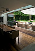 CONTEMPORARY TOWN/CITY/URBAN GARDEN DESIGNED BY CHARLOTTE SANDERSON: VIEW FROM INSIDE DINING AREA TO OUTSIDE ENTERTAINING AREA WITH AWNING OVER TABLE  CHAIRS AND SOFAS