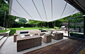 CONTEMPORARY TOWN/CITY/URBAN GARDEN DESIGNED BY CHARLOTTE SANDERSON: VIEW OUT TO AWNING OVER ENTERTAINING/RELAXING/DINING AREA WITH TABLE  CHAIRS AND SOFAS
