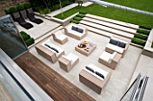 URBAN CONTEMPORARY MODERN MINIMALIST GARDEN DESIGNED BY CHARLOTTE SANDERSON: VIEW FROM ROOF ONTO PAVED PATIO AREA WITH TABLE AND CHAIRS  STEPS UP TO LAWN