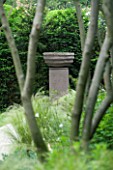 URBAN CONTEMPORARY MODERN MINIMALIST GARDEN DESIGNED BY CHARLOTTE SANDERSON: VIEW THROUGH TREES TO FOCAL POINT OF URN AT THE END OF A PATH