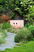 GARDEN DESIGNED BY CHARLOTTE SANDERSON: GREY SLATE PATH LEADS TO PINK RENDERED CEMENT WATER FEATURE