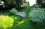 THE OLD RECTORY  HASELBECH  NORTHAMPTONSHIRE. A PLACE TO SIT - EARLY MORNING SUNLIGHT HITS BEAUTIFUL WOODEN BENCH/ SEAT BESIDE WILDFLOWER MEADOW