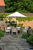 THE OLD RECTORY  HASELBECH  NORTHAMPTONSHIRE: PATIO WITH TABLE AND CHAIRS AND PARASOL