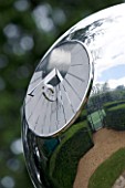 DETAIL OF SUNDIAL BY DAVID HARBER: STAINLESS STEEL MIRRORED GLOBE SUNDIAL. REFLECTION