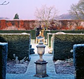 VIEW ACROSS THE MAIN LAWN WITH FORMAL TOPIARY & URNS. HAZELBURY MANOR GARDEN  WILTSHIRE