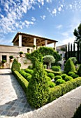 DESIGNER MICHEL SEMINI  PROVENCE  FRANCE. THE FORMAL GARDEN WITH BOX EDGED BEDS AND RAISED SUMMERHOUSE