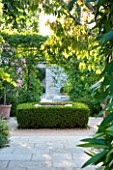 DESIGNER MICHEL SEMINI  PROVENCE  FRANCE. VIEW OF COURTYARD WITH WELL SURROUNDED BY BOX HEDGING