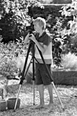 ROBERT NICHOLS IN HIS GARDEN WITH MANFROTTO 058B TRIPOD AND 410 GEARED HEAD - BLACK AND WHITE IMAGE
