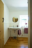 DESIGNER CLARE MATTHEWS: DEVON  THE BATHROOM WITH SINK  PURPLE TOWELS AND MIRROR