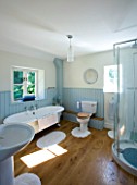 DESIGNER CLARE MATTHEWS: DEVON  BLUE AND WHITE THEMED BATHROOM WITH SHOWER AND ROLL TOP BATH