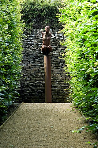 THROUGHAM_COURT__GLOUCESTERSHIRE_DESIGNER_CHRISTINE_FACER_RED_WALK_WITH_CROUCHING_WOMAN_SCULPTURE_BY