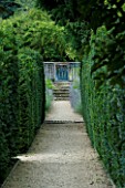 THROUGHAM COURT  GLOUCESTERSHIRE. DESIGNER: CHRISTINE FACER: VIEW ALONG YEW LINED PATH TO THE CHAOS GATE