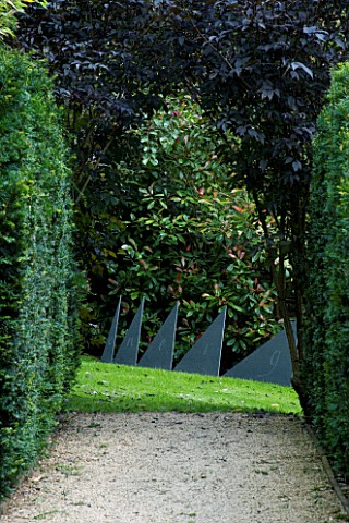 THROUGHAM_COURT__GLOUCESTERSHIRE_DESIGNER_CHRISTINE_FACER_VIEW_ALONG_YEW_LINED_PATH_TO_ENERGIES__CUM