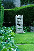 THROUGHAM COURT  GLOUCESTERSHIRE. DESIGNER: CHRISTINE FACER: LEXICON BATH STONE SCULPTURE BY TOM SHUTTERS IN THE LIBRARY GARDEN
