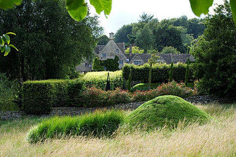 THROUGHAM_COURT__GLOUCESTERSHIRE_DESIGNER_CHRISTINE_FACER_THE_COURT_SEEN_FROM_THE_WALNUT_QUINCUNX_WI