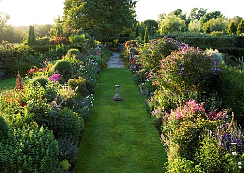 WILKINS_PLECK__STAFFORDSHIRE_VIEW_FROM_THE_HOUSE_ALONG_GRASS_PATH_WITH_DOUBLE_HERBACEOUS_BORDER