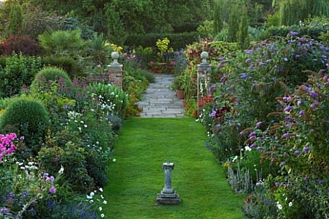 WILKINS_PLECK__STAFFORDSHIRE_VIEW_FROM_THE_HOUSE_ALONG_GRASS_PATH_WITH_DOUBLE_HERBACEOUS_BORDER_AND_