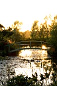 WILKINS PLECK  STAFFORDSHIRE: THE LAKE AND MONET STYLE BLUE BRIDGE AT SUNSET