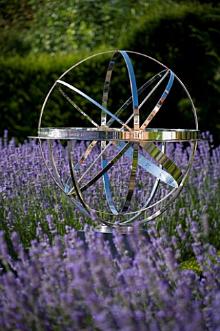 DAVID_HARBER_SUNDIALS_STAINLESS_STEEL_ARMILLARY_SPHERE_SUNDIAL_SURROUNDED_BY_BOX_HEDGES_AND_LAVENDER