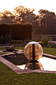 DAVID HARBER SUNDIALS: ETHER WATER FEATURE IN A POOL IN EARLY MORNING DAWN LIGHT