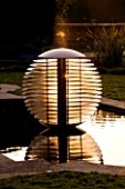 DAVID HARBER SUNDIALS: ETHER WATER FEATURE IN A POOL IN EARLY MORNING DAWN LIGHT