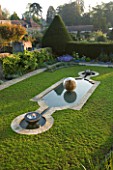 DAVID HARBER SUNDIALS: CHALICE WATER FEATURE AND ETHER WATER FEATURE IN A POOL IN EARLY MORNING DAWN LIGHT. CHAMOMILE LAWN  FORMAL GARDEN.